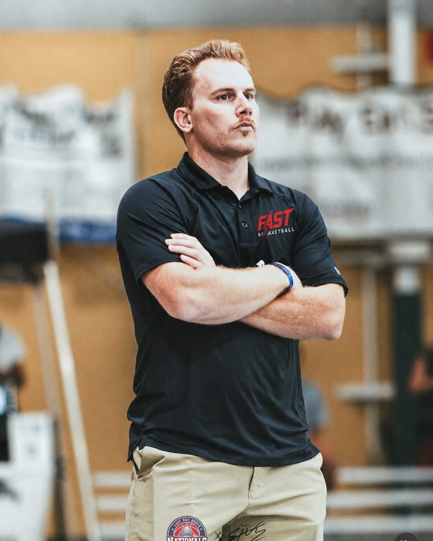 Coach Blake Kingsley, founder of Fast Basketball, courtside in a Fast Basketball polo